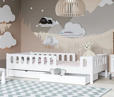 A child's bedroom with a white bed, cloud-shaped wall decorations, and a mountain-themed mural.