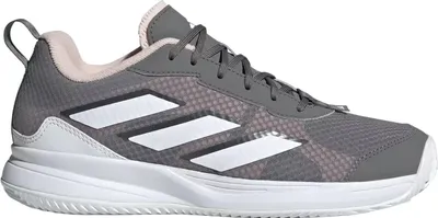 A side view of a single Adidas tennis shoe.