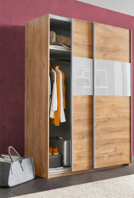 A wardrobe with sliding doors, partially open to reveal clothes and luggage inside. A grey tote bag is on the floor next to it.