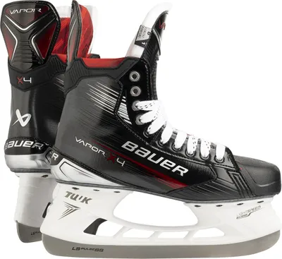 A pair of black and red Bauer Vapor X4 ice hockey skates are shown from a side-angle.