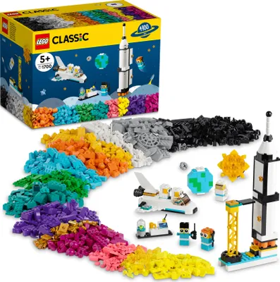 A LEGO Classic space-themed building set with various colored bricks and assembled models of a rocket, space shuttle, and astronauts.