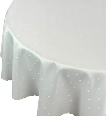 A close-up, angled view of a white, round tablecloth with a subtle white polka dot pattern.