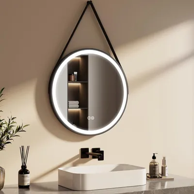 A modern bathroom vanity area with a round LED mirror above a rectangular sink.