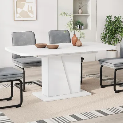 A white dining table with gray chairs in a dining room setting.