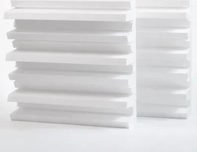 Two stacks of white styrofoam panels are arranged on a white surface.