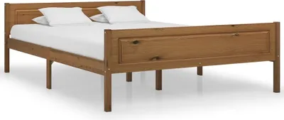 A wooden bed with white pillows and mattress, shown from a side angle with a white background.