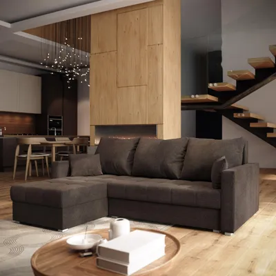 A modern living room with a sectional sofa, fireplace, and staircase.