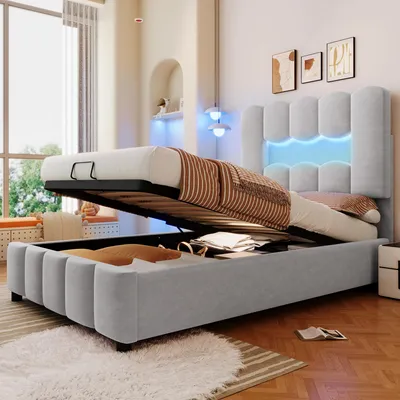 A bed with its storage compartment open, in a well-lit room.
