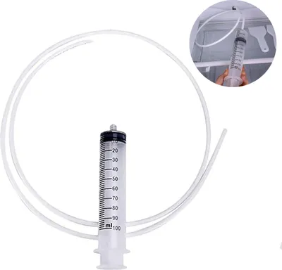 A clear shot of a syringe with a flexible tube attached, set against a white background.