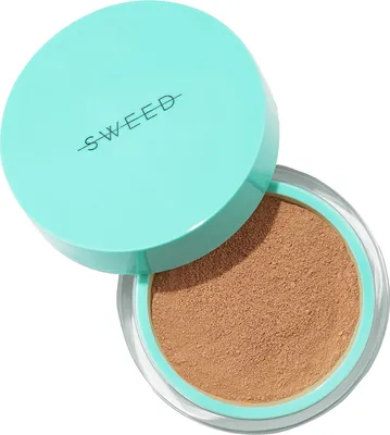 A container of loose powder makeup with the lid slightly ajar.
