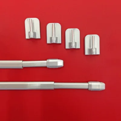 A product shot of extendable curtain rods and adhesive hooks on a red background.