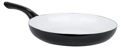 A black frying pan with a white interior and a black handle is shown against a white background.