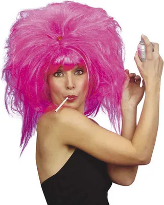 A woman wearing a large pink wig and a black top, holding a cigarette in her mouth and a can of hairspray.