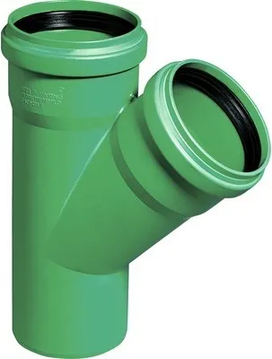 A green PVC pipe fitting with two openings branching off from a main pipe.