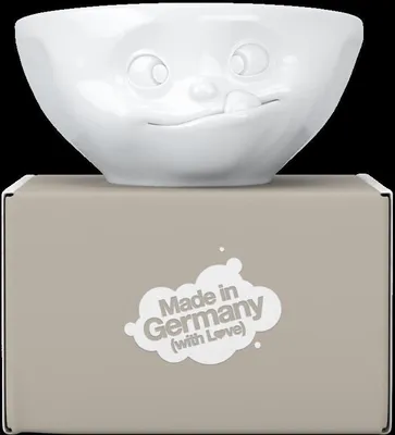 A white ceramic bowl with a face design sits on top of its packaging box.