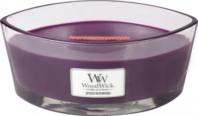 A close-up, studio shot of a WoodWick Spiced Blackberry scented candle in a clear glass container.