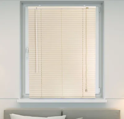 A window with cream-colored blinds.