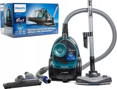 A Philips vacuum cleaner and its accessories are displayed against a white background, with the product's packaging visible in the upper left corner.