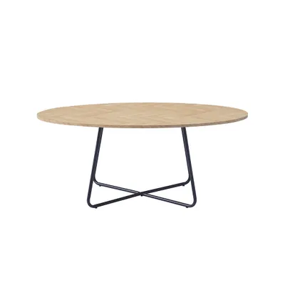 A round coffee table with a herringbone wood top and a black metal base.