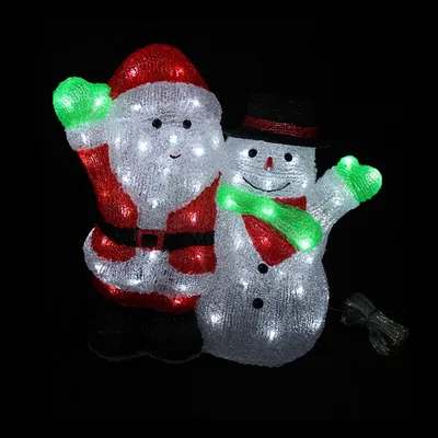 A lit-up Christmas decoration of Santa Claus and a snowman against a black background.