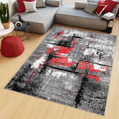 A modern living room with a sectional sofa, a rug, and a small table.