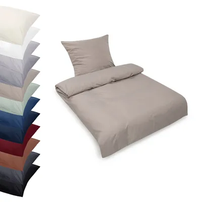 A bedding set displayed on a white background, with a stack of different colored bedding sets to the left.