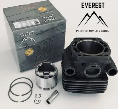 A product shot of a chainsaw cylinder and piston kit, with the product packaging in the background.