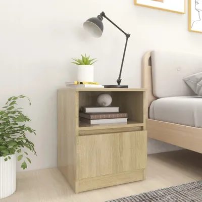A bedside table with a lamp, books, and a plant.