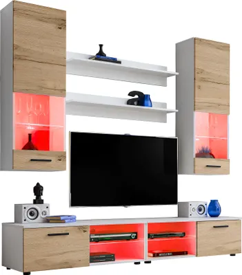 A modern living room entertainment unit with cabinets, shelves, and a TV stand, illuminated by LED lights.