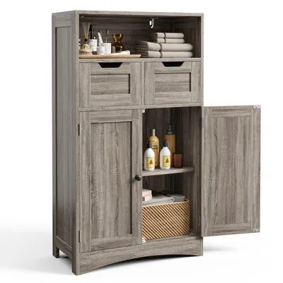 A tall, narrow cabinet with two doors and two drawers, made of wood-like material, is shown against a white background. The cabinet is open, revealing shelves with various items like bottles and towels.