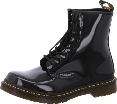 A black patent leather Dr. Martens boot is shown against a white background.