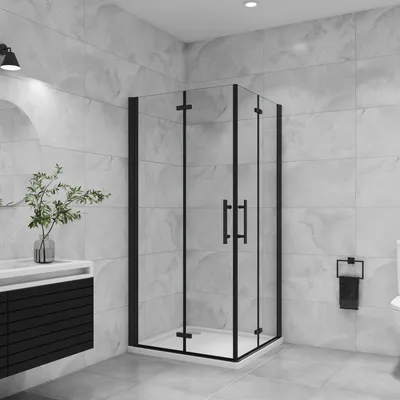 A modern bathroom with a black framed glass shower enclosure.