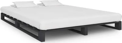 A bed frame with a mattress and pillows on a white background.