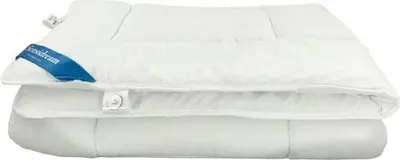 A white duvet or comforter folded on top of another white duvet or comforter.