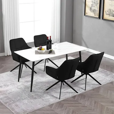 A dining table with chairs and wine bottles.