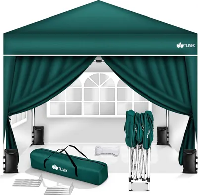 A green pop-up gazebo with its accessories laid out in front of it, including a carrying bag, weights, and a folded frame.