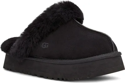A black UGG slipper with fur trim on a white background.