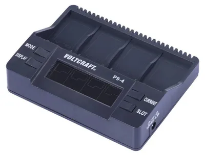 A close-up, angled view of a black battery charger with multiple slots and a digital display.