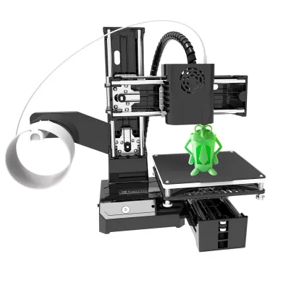 A 3D printer with a small green frog figurine on its print bed.