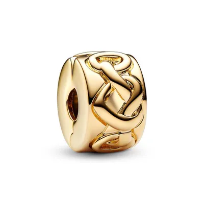 A close-up studio shot of a gold clip charm with a Celtic knot design.