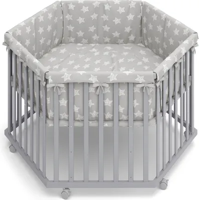 A hexagonal baby playpen with a grey frame and a grey mattress and bumper pad featuring a white star pattern.