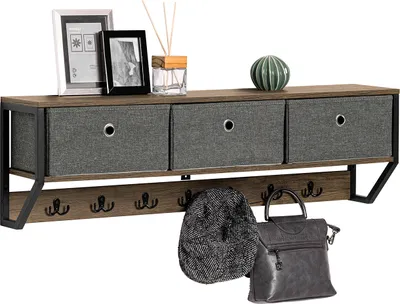 A wall-mounted shelf with fabric drawers and hooks, along with decorative items and accessories like a hat and handbag.