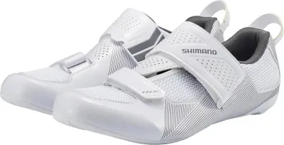 A pair of white and gray Shimano cycling shoes are shown against a white background.