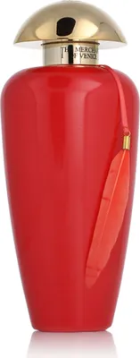 A red perfume bottle with a gold cap and a red tassel.