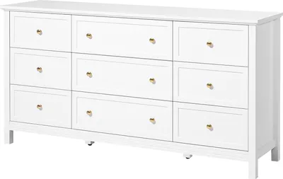 A white dresser with nine drawers and gold knobs, shown from a slightly angled front view.