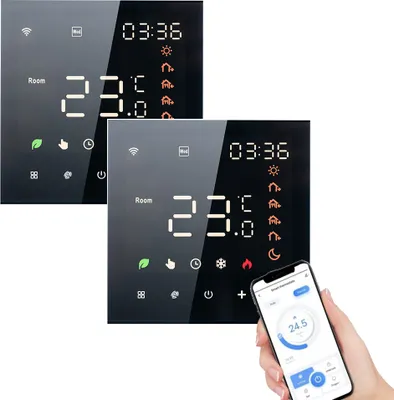 Two smart thermostats are shown, one partially obscured by a hand holding a smartphone displaying a thermostat app.