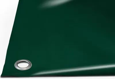 A close-up, angled view of a dark green tarp with a metal grommet visible in the lower left corner.