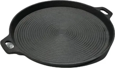 A black cast iron griddle pan with concentric ridges and two handles, shown from a slightly elevated angle on a white background.