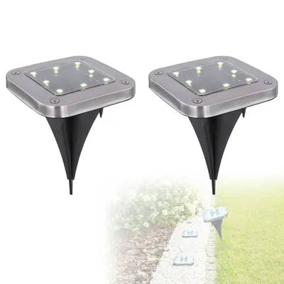 Two solar-powered garden lights are shown against a white and blurred background of a garden path and greenery.
