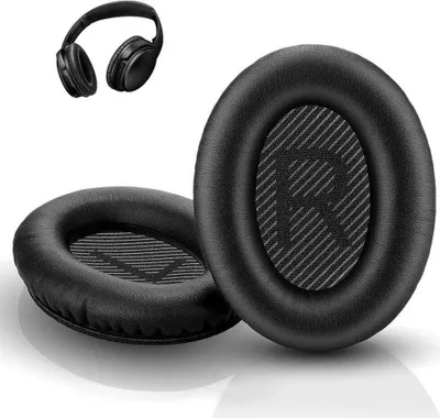 A pair of black headphone ear pads and a pair of black headphones are shown on a white background.